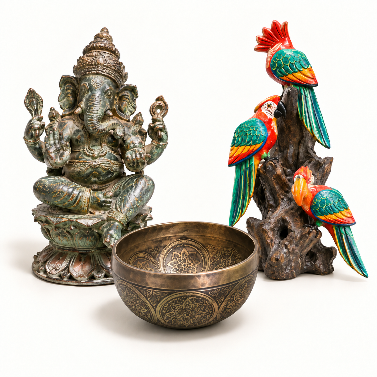 Carved Ganesha, engraved singing bowl and painted parrot sculpture